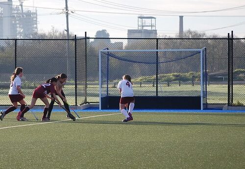 Hockey match in progress with girls participating